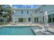 Backyard oasis featuring a sparkling pool, jacuzzi, patio seating, and lush landscaping, ideal for entertaining at 1076 Toc0Baga, Sarasota, FL 34234