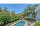 Aerial view of a private pool and backyard surrounded by lush tropical landscaping, perfect for relaxation at 1076 Toc0Baga, Sarasota, FL 34234