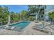 Inviting backyard with a refreshing pool, jacuzzi, outdoor seating, and sun loungers for relaxation at 1076 Toc0Baga, Sarasota, FL 34234