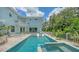 Gorgeous backyard with a sparkling private pool and spa with the property bordered by tropical plants at 1076 Toc0Baga, Sarasota, FL 34234