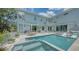 Backyard with a beautiful private pool, hot tub, dining table, and chairs, perfect for relaxing and entertaining guests at 1076 Toc0Baga, Sarasota, FL 34234