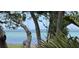 Stunning water view framed by mature trees, offering a serene and private setting at 1076 Toc0Baga, Sarasota, FL 34234