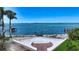 Gorgeous waterfront view with a private dock, palm trees, and city skyline on the horizon at 1076 Toc0Baga, Sarasota, FL 34234
