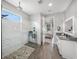 Bright bathroom with a glass-enclosed shower, stone floor, and view of a bedroom at 11422 Apple Tree Cir, Bradenton, FL 34211