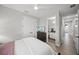 A stylish bedroom features a walk-in closet and an attached bathroom with modern finishes at 11422 Apple Tree Cir, Bradenton, FL 34211