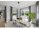 Bright dining room with modern chandelier, and a view of the backyard and pool at 11422 Apple Tree Cir, Bradenton, FL 34211