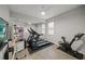 Home exercise room with treadmills, a stationary bike, and a large mirror at 11422 Apple Tree Cir, Bradenton, FL 34211