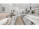 Bright kitchen featuring white cabinetry, stainless steel appliances, and a large waterfall island at 11422 Apple Tree Cir, Bradenton, FL 34211