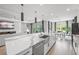 Elegant kitchen with a waterfall island, stainless appliances, and an open view to the dining area at 11422 Apple Tree Cir, Bradenton, FL 34211