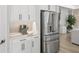 Close-up of a stainless steel refrigerator and matching coffee machine with white cabinets at 11422 Apple Tree Cir, Bradenton, FL 34211
