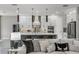 Open-concept kitchen with waterfall island, stainless appliances, and bar seating adjacent to the living room at 11422 Apple Tree Cir, Bradenton, FL 34211