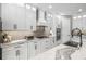 Well-equipped kitchen featuring stainless steel appliances, white cabinetry, and modern fixtures at 11422 Apple Tree Cir, Bradenton, FL 34211