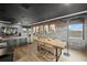 Modern living and dining area with exposed brick walls, hardwood floors, and neutral decor at 11422 Apple Tree Cir, Bradenton, FL 34211