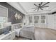 Charming main bedroom with tray ceilings, a ceiling fan, and many windows with natural light at 11422 Apple Tree Cir, Bradenton, FL 34211