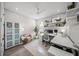 Bright home office with a ceiling fan, built-in shelves, and a comfortable seating area at 11422 Apple Tree Cir, Bradenton, FL 34211