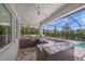 Outdoor kitchen and bar area on a screened patio with a view of the pool and backyard at 11422 Apple Tree Cir, Bradenton, FL 34211