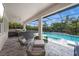 View of the outdoor living and pool area from the screened in patio, featuring comfortable seating at 11422 Apple Tree Cir, Bradenton, FL 34211