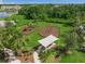 Aerial view of the community playground with modern equipment, shaded picnic area, and walking paths at 11422 Apple Tree Cir, Bradenton, FL 34211