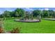 Community playground featuring modern slides, swings, and climbing structures, perfect for outdoor fun at 11422 Apple Tree Cir, Bradenton, FL 34211
