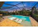 Stunning screened-in pool and spa with built-in loungers, surrounded by lush landscaping at 11422 Apple Tree Cir, Bradenton, FL 34211