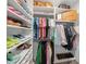 Organized walk-in closet with shelves for shoes, hanging clothes, and storage boxes at 11422 Apple Tree Cir, Bradenton, FL 34211