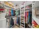 Spacious walk-in closet with built-in shelves and hanging rods for ample clothing storage at 11422 Apple Tree Cir, Bradenton, FL 34211