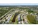 A scenic aerial view of a home with a beautiful private pool surrounded by lush greenery and a serene pond at 11839 Shrewsbury Ln, Parrish, FL 34219