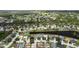 Aerial view of the home's location in a neighborhood with ponds and mature trees; golf course in distance at 11839 Shrewsbury Ln, Parrish, FL 34219