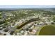 Gorgeous aerial view of a neighborhood with a private pool home nestled along a tranquil pond and lush greenery at 11839 Shrewsbury Ln, Parrish, FL 34219