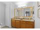 Bathroom featuring double sinks with granite countertops and a large mirror at 11839 Shrewsbury Ln, Parrish, FL 34219