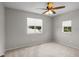 Bright bedroom with soft carpet flooring and two large windows offering ample natural light at 11839 Shrewsbury Ln, Parrish, FL 34219