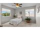 Cozy bedroom with bright windows, soft carpet, and a ceiling fan for comfort at 11839 Shrewsbury Ln, Parrish, FL 34219