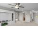 Large bonus room with neutral colors, ceiling fan, and a built-in bookshelf at 11839 Shrewsbury Ln, Parrish, FL 34219
