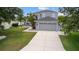 Charming two-story home with an attached two-car garage, surrounded by mature trees and lush landscaping at 11839 Shrewsbury Ln, Parrish, FL 34219