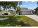 Charming two-story home features a well-manicured lawn, mature trees, and an attached two-car garage at 11839 Shrewsbury Ln, Parrish, FL 34219