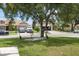 Charming home featuring a well-maintained lawn, mature tree, and beautiful landscaping at 11839 Shrewsbury Ln, Parrish, FL 34219