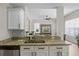 Kitchen with granite countertops, stainless steel sink, and open layout to living areas at 11839 Shrewsbury Ln, Parrish, FL 34219