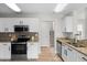 Modern kitchen with stainless appliances, granite countertops, and mosaic backsplash at 11839 Shrewsbury Ln, Parrish, FL 34219