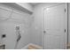 Functional laundry room with a wire rack shelf, utility hookups, and a sturdy door at 11839 Shrewsbury Ln, Parrish, FL 34219