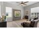 Bright living room with wood floors, comfortable seating, and large windows providing plenty of natural light at 11839 Shrewsbury Ln, Parrish, FL 34219