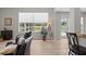 Light-filled living room with wood floors, comfortable seating, and a view of the backyard pool at 11839 Shrewsbury Ln, Parrish, FL 34219