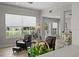 Bright living room with wood floors, comfortable seating, backyard views, and access to outdoor amenities at 11839 Shrewsbury Ln, Parrish, FL 34219