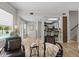 Open-concept living area with wood floors, cozy seating, and a view of the outdoor pool area at 11839 Shrewsbury Ln, Parrish, FL 34219