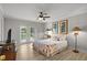 This main bedroom has pool access, a ceiling fan, and two framed decorative pictures at 11839 Shrewsbury Ln, Parrish, FL 34219