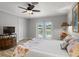 This main bedroom has a ceiling fan, pool access, and is decorated in neutral colors at 11839 Shrewsbury Ln, Parrish, FL 34219