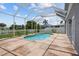 Screened pool with stone tile, ample patio space, and views of the backyard, landscaping, and neighborhood at 11839 Shrewsbury Ln, Parrish, FL 34219