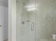 The glass shower has a shower head with a wand and decorative tile at 11839 Shrewsbury Ln, Parrish, FL 34219