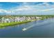 Beautiful waterfront condos with boat cruising along the calm waters on a sunny day at 1240 Siesta Bayside Dr # 1240C, Sarasota, FL 34242