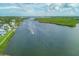 Scenic aerial view showcasing the waterfront property with lush green surroundings and a boat on the expansive water at 1240 Siesta Bayside Dr # 1240C, Sarasota, FL 34242