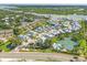 Aerial view showing the community of waterfront townhomes with pool, tennis courts, and boat access at 1240 Siesta Bayside Dr # 1240C, Sarasota, FL 34242